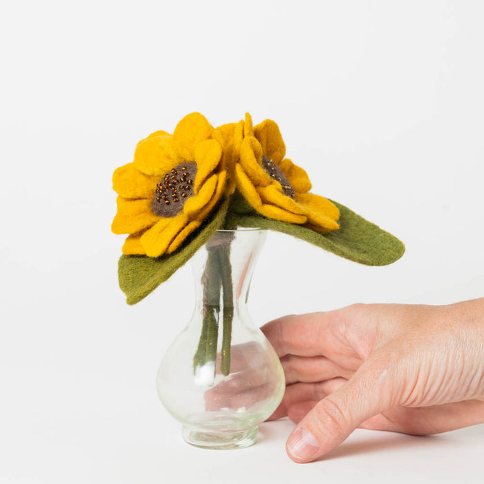 Small felt sunflower bouquet with a felt bee in a clear glass vase, made from recycled materials.