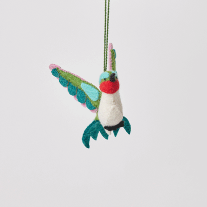 Craftspring’s Little Migrator Hummingbird Ornament from the Iconic Craftspring Ornaments Bundle rotating to show front, side, and back views — felt hummingbird with embroidered and beaded details, a whimsical ornament perfect for holiday gifting — heirloom-quality Christmas decor, ethically crafted by artisans using sustainable wool.