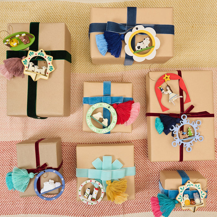 Handcrafted ornament made from wood and locally sourced clay with attached hanging string