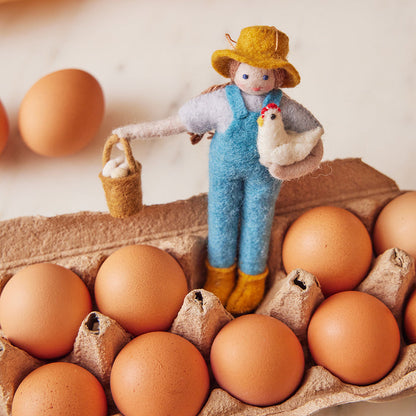 Artisan wool ornament of woman farmer with fresh eggs and chicken – perfect gift for farm-to-table enthusiasts and gardeners.