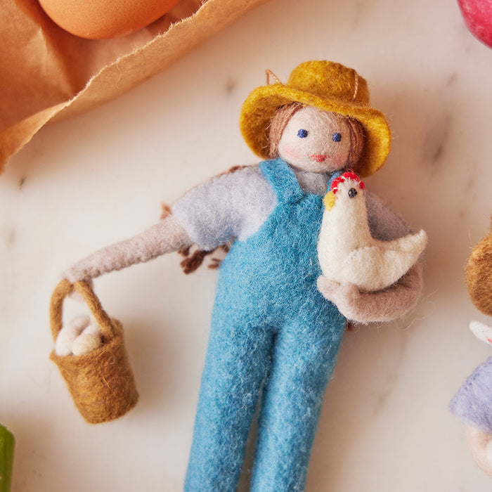 Fair trade wool ornament of female farmer with chicken – handmade in Kyrgyzstan from natural felted wool.
