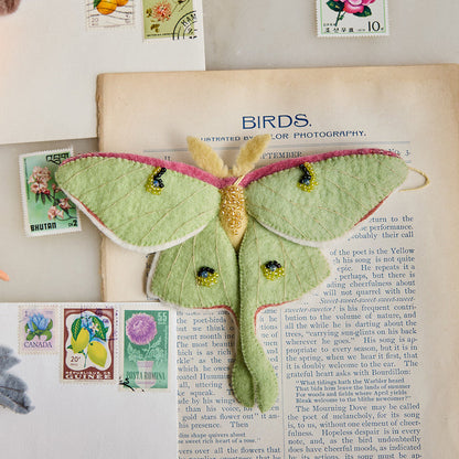 Ethereal green Luna Moth ornament with embroidered wings and beaded details, handcrafted from felted wool and inspired by the magic of twilight skies and woodland nature
