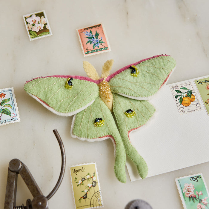 Whimsical green felt Luna Moth ornament with shimmering bead accents, handmade in Kyrgyzstan and supporting pollinator education programs