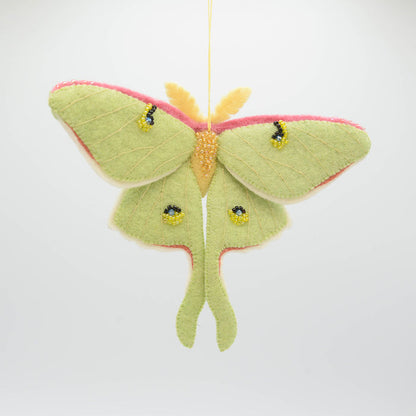 Pollinator-themed wool ornament featuring a luminous Luna Moth with fair trade craftsmanship