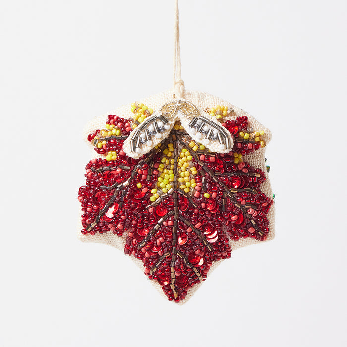 Hand-beaded maple leaf ornament with rich jewel-toned beads and delicate samara seed pods on linen backing.