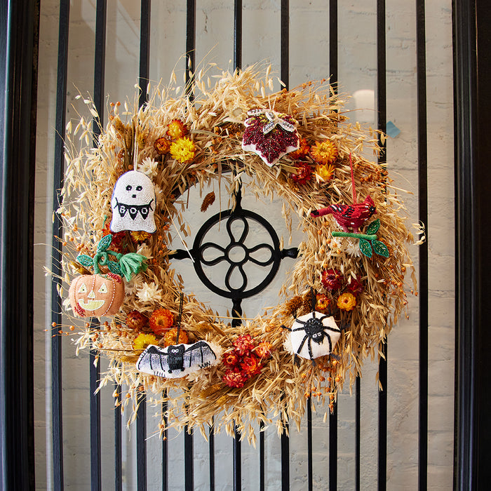 Seasonal maple leaf ornament with rich beadwork and natural motifs, handcrafted and ready to hang for autumn celebrations.