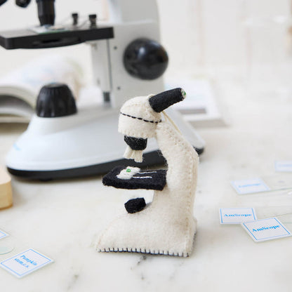 Celebrate curiosity, discovery, and the wonders of science with our handmade Felt Microscope Ornament — a charming keepsake perfect for scientists, biology lovers, teachers, researchers, lab technicians, and STEM enthusiasts.