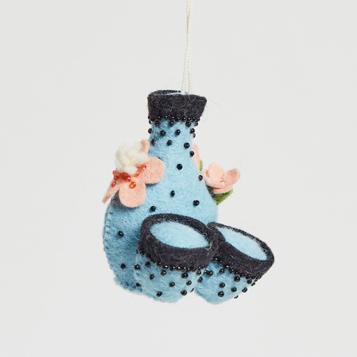 Japanese sake set ornament featuring felted flask and cups with cherry blossoms, symbolizing hospitality and spring renewal. GIF