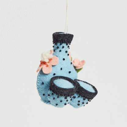 Japanese sake set ornament featuring felted flask and cups with cherry blossoms, symbolizing hospitality and spring renewal. GIF