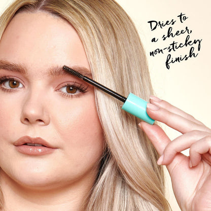 Model applying the brow gel to her eyebrows.