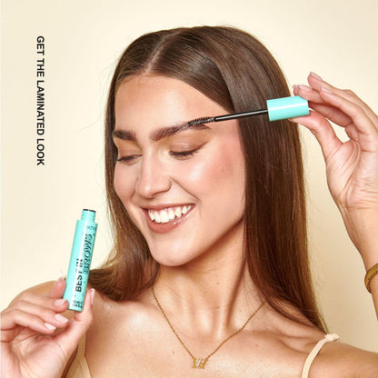A model applying the brow gel with text next to her saying "Get the laminated look"