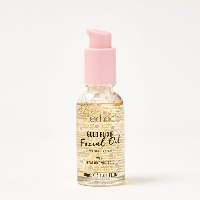 A gold elixir facial oil in front of a white background.