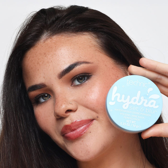 Technic Hydra Set & Blur water-based loose powder compact held near cheek
