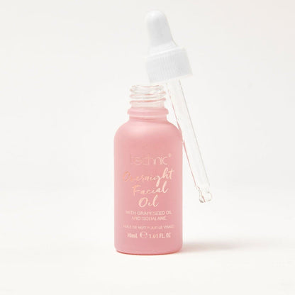 An opened overnight facial oil in front of a white background.